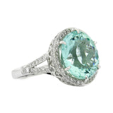 aquamarine and diamond halo ring, claw set with split shoulders